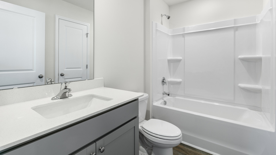 secondary bathroom with shower tub combo and single vanity sink