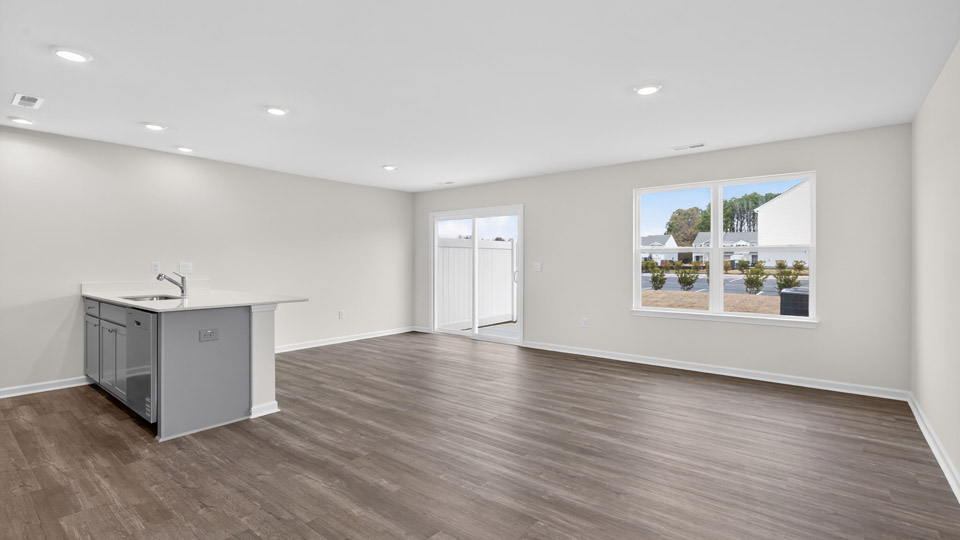 Open-concept living room leading to kitchen