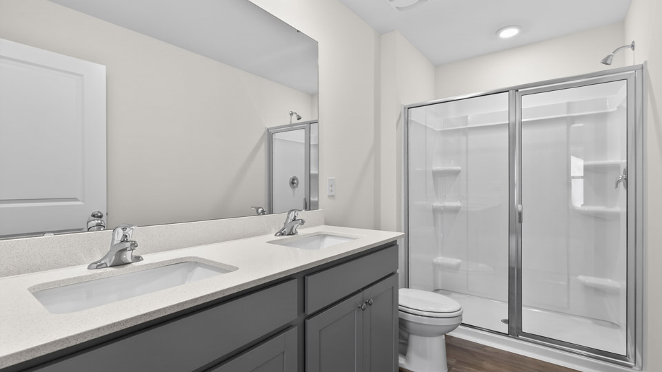 Primary bathroom with double sink and walk-in shower