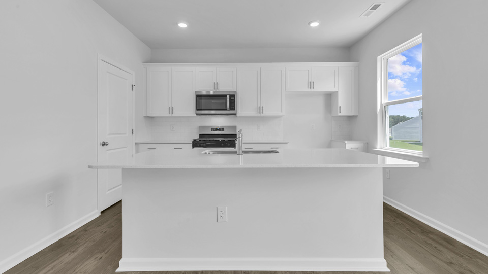 kitchen with white cabinets quartz countertops and stainless steel appliances