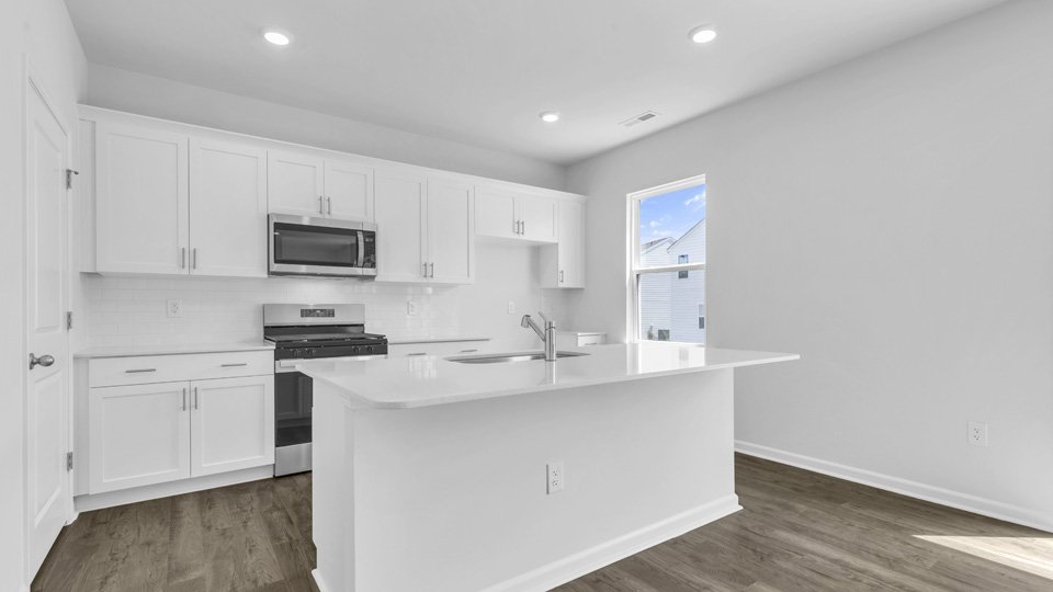 kitchen with white cabinets quartz countertops and stainless steel appliances