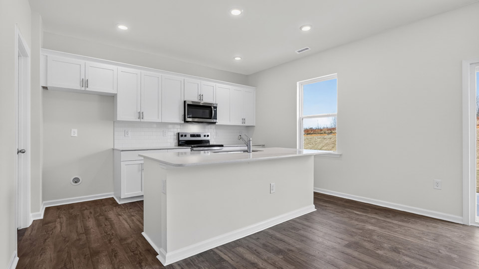 Kitchen with white cabinets and stainless steel appliances.