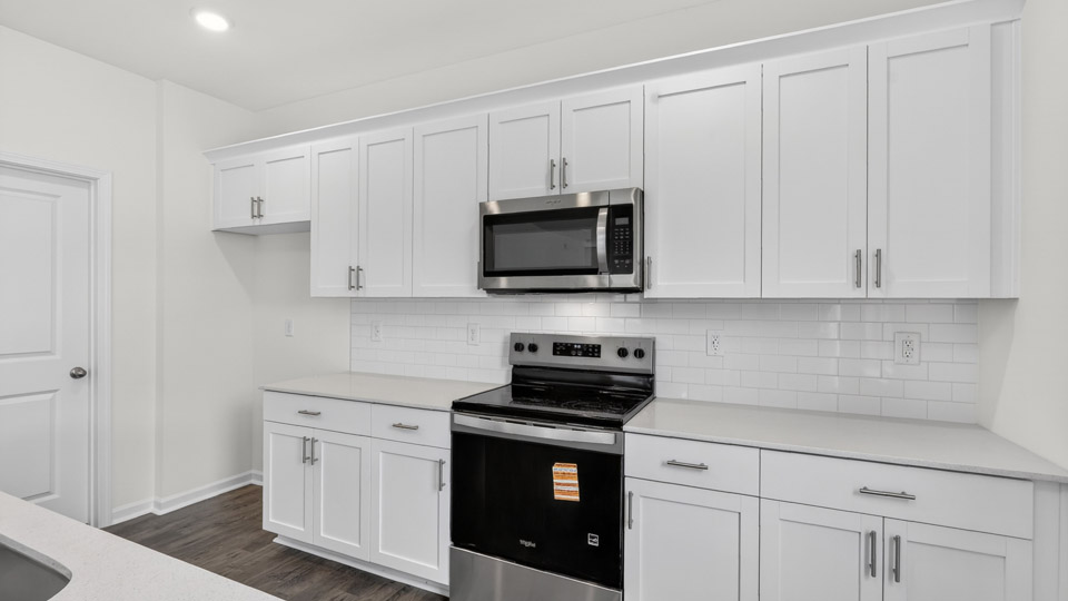 Kitchen with white cabinets and stainless steel appliances.