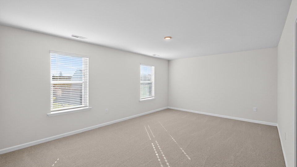 Primary bedroom with carpet flooring