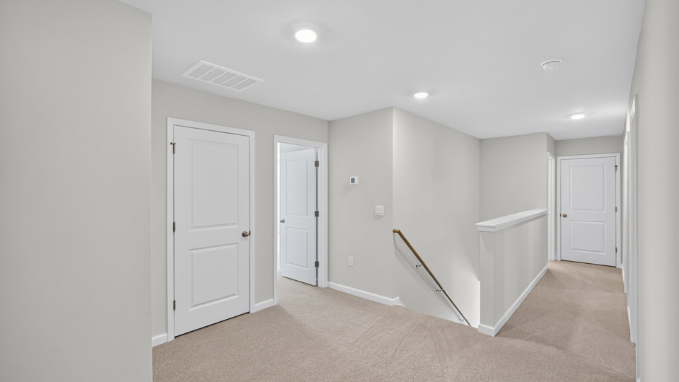 Upstairs hallway with carpet flooring