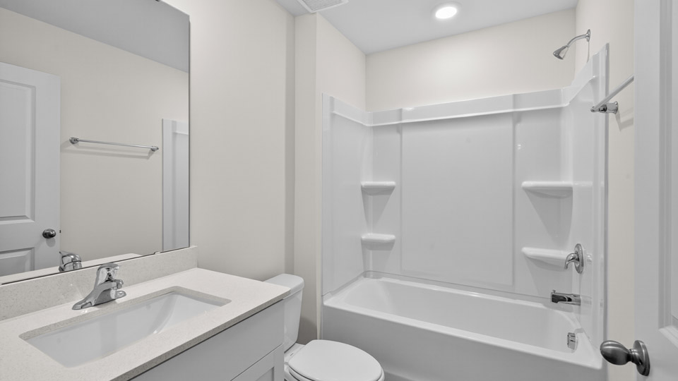 bathroom with quartz countertops and tubshower combo