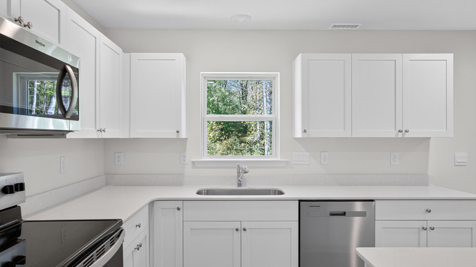 kitchen with white cabinets and quartz countertops