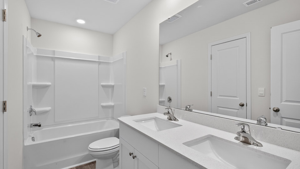 bathroom with quartz countertops and tubshower combo