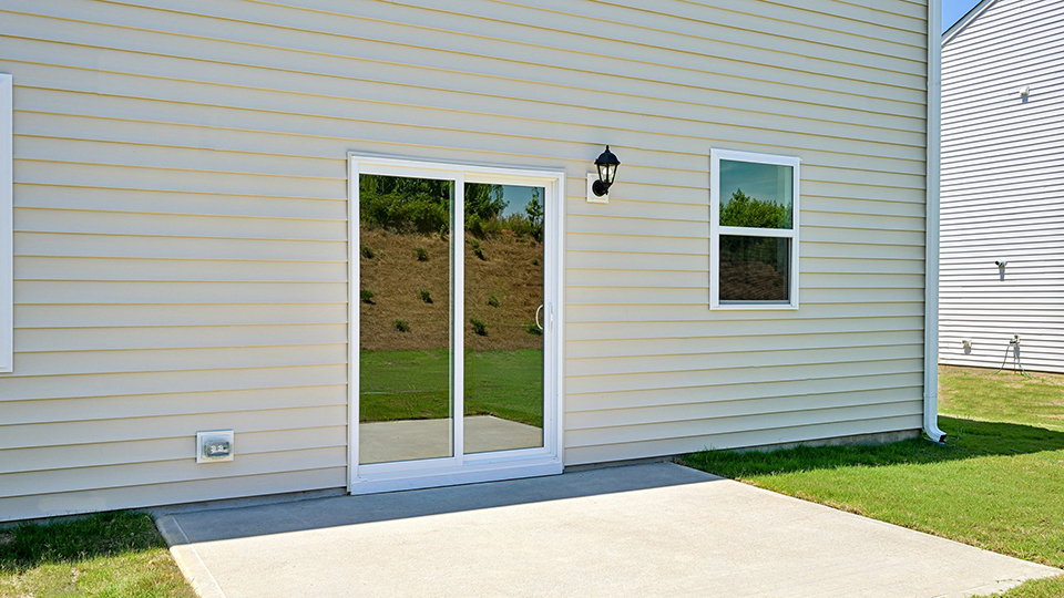 exterior patio with concrete slab and open yard