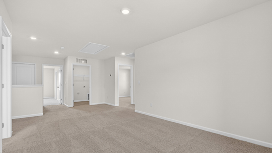 upstairs loft area with large windows and carpeting
