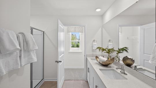 bathroom with white cabinets and quartz countertops