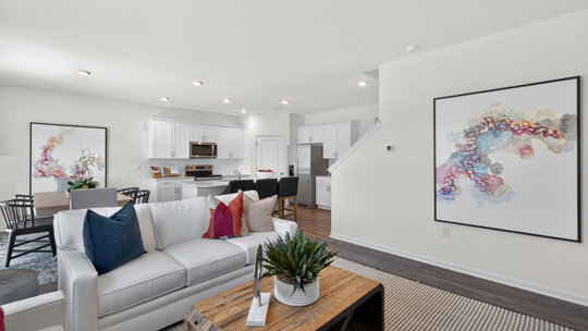 open concept living room overlooked by kitchen
