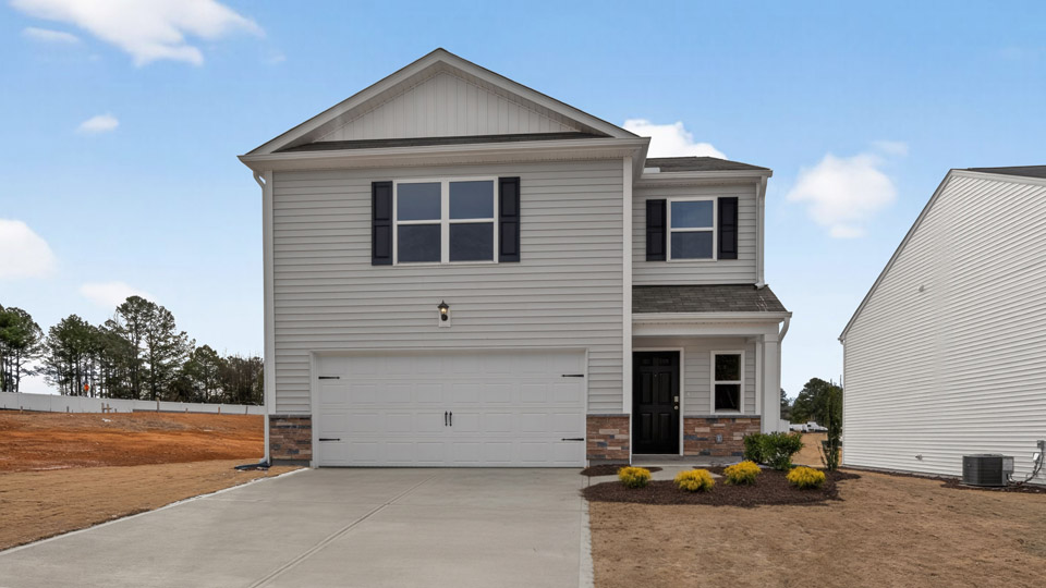 Two story home with white colored siding with a two car garage