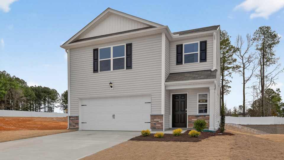 Two story home with white colored siding with a two car garage
