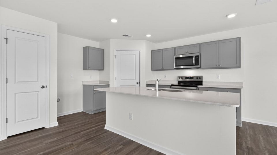 Kitchen with gray cabinets and stainless steel appliances.