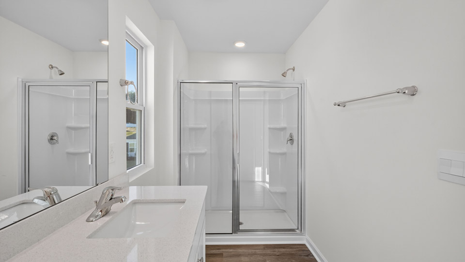 Primary bathroom with double sink and walk-in shower