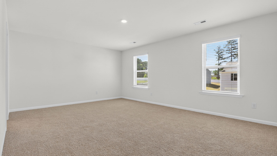primary bedroom with carpet flooring