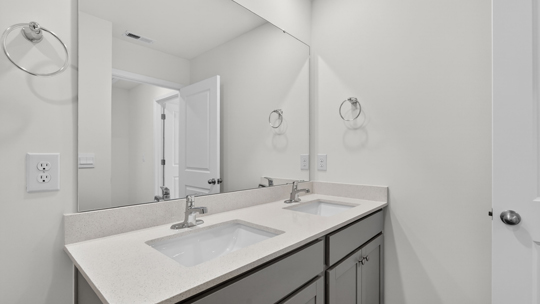 bathroom with quartz countertops and gray cabinets