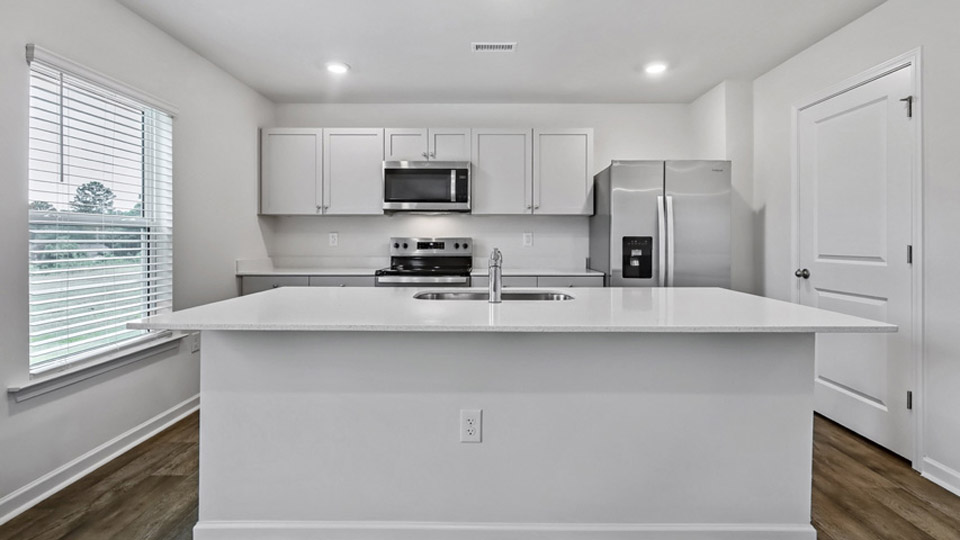 kitchen with gray cabinets and quartz counters