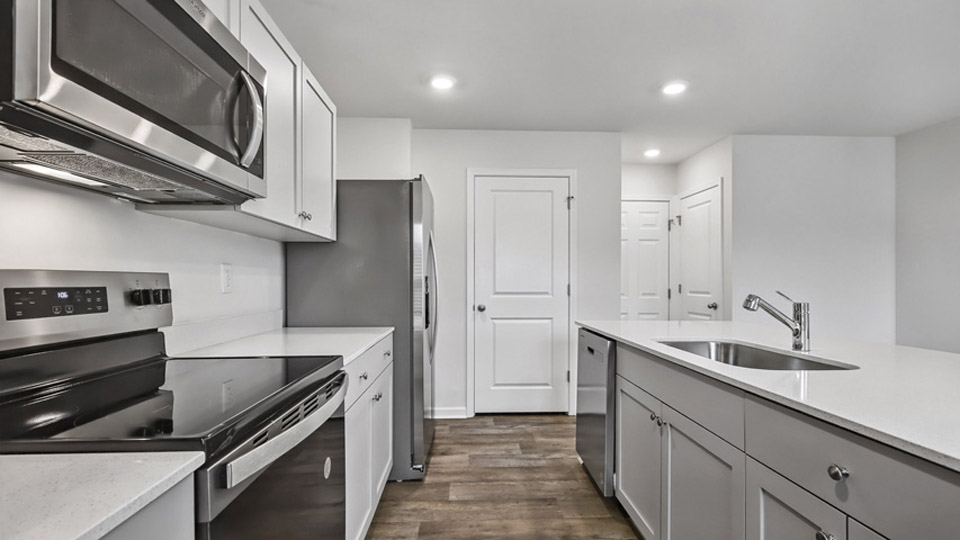 kitchen with gray cabinets and quartz counters