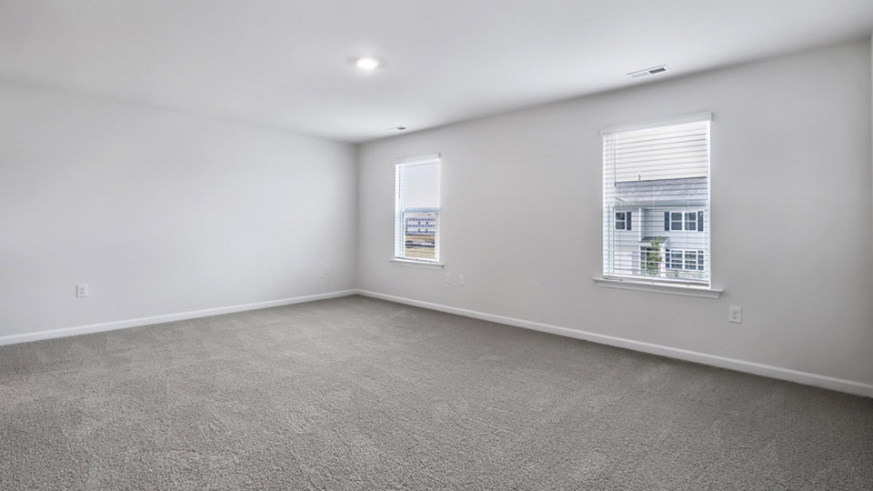 primary bedroom with bathroom attached, carpet