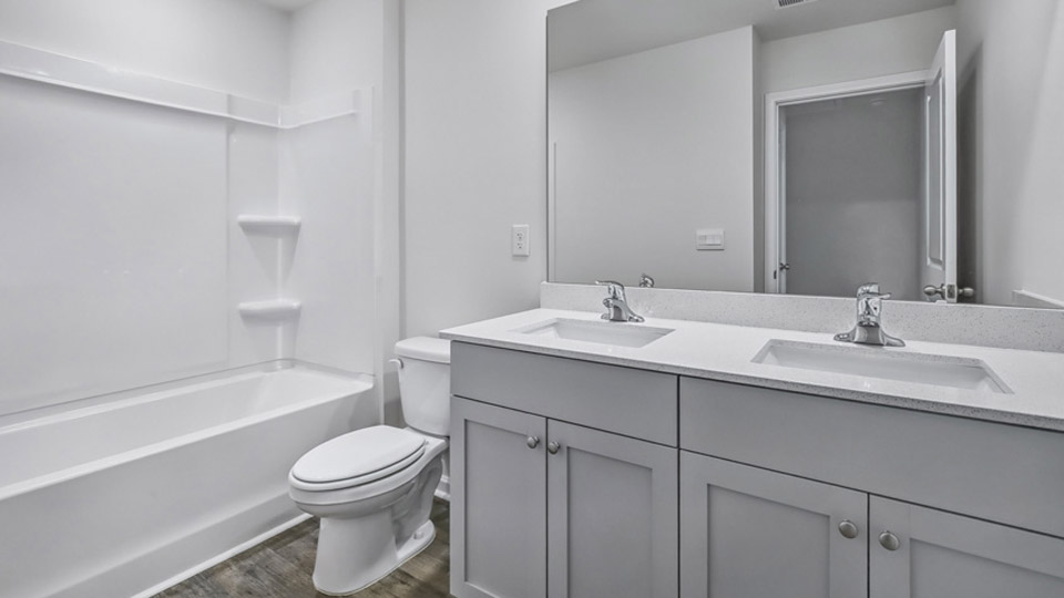 secondary bathroom with dual sinks