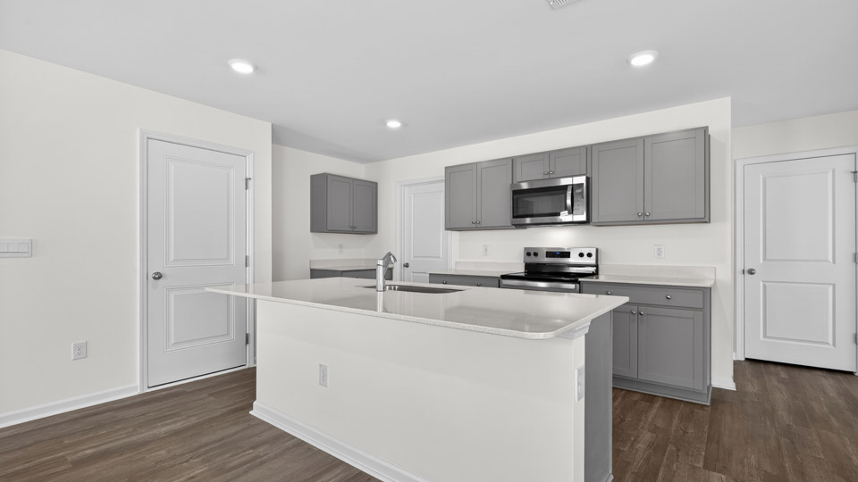 Kitchen with gray cabinets and stainless steel appliances.