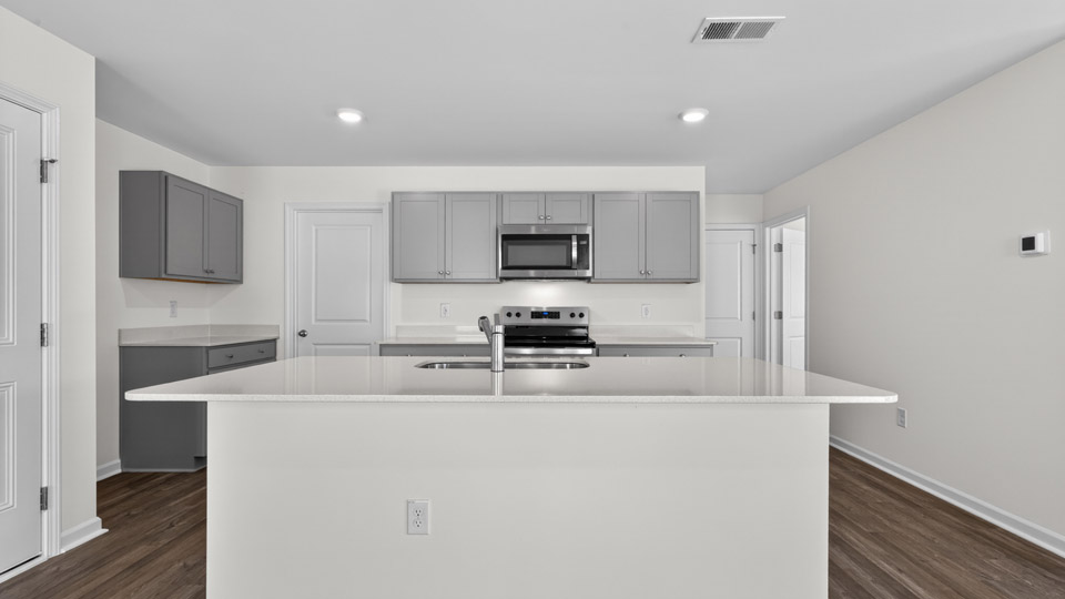 Kitchen with gray cabinets and stainless steel appliances.