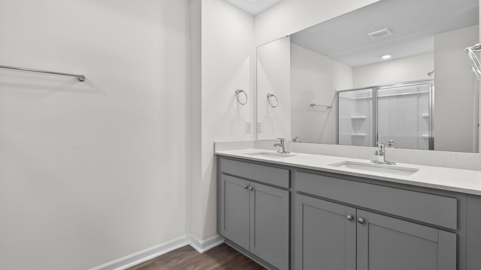 Primary bathroom with double sink and walk-in shower