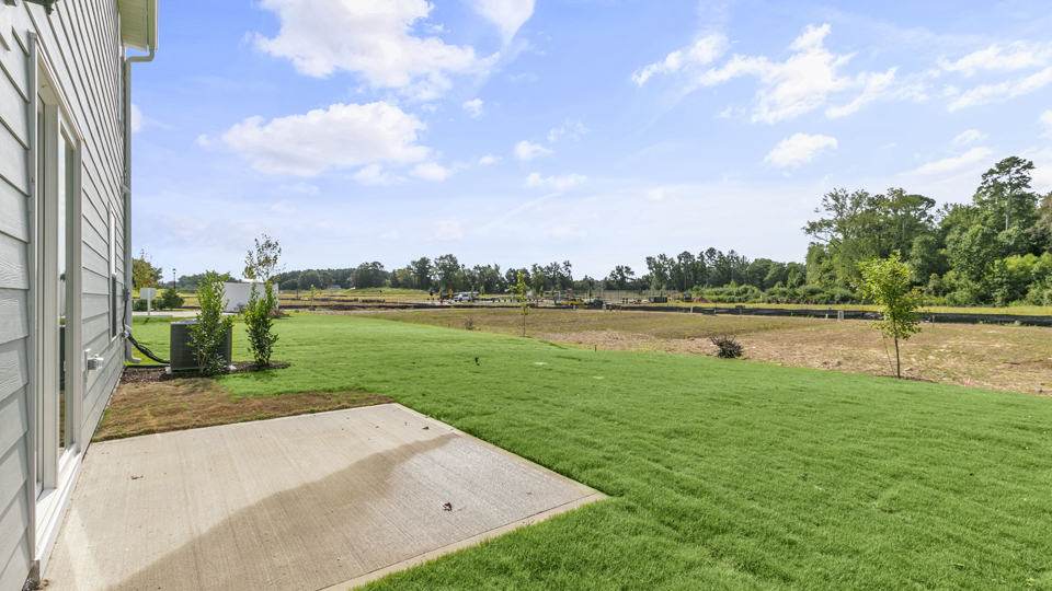exterior patio with concrete slab and open yard
