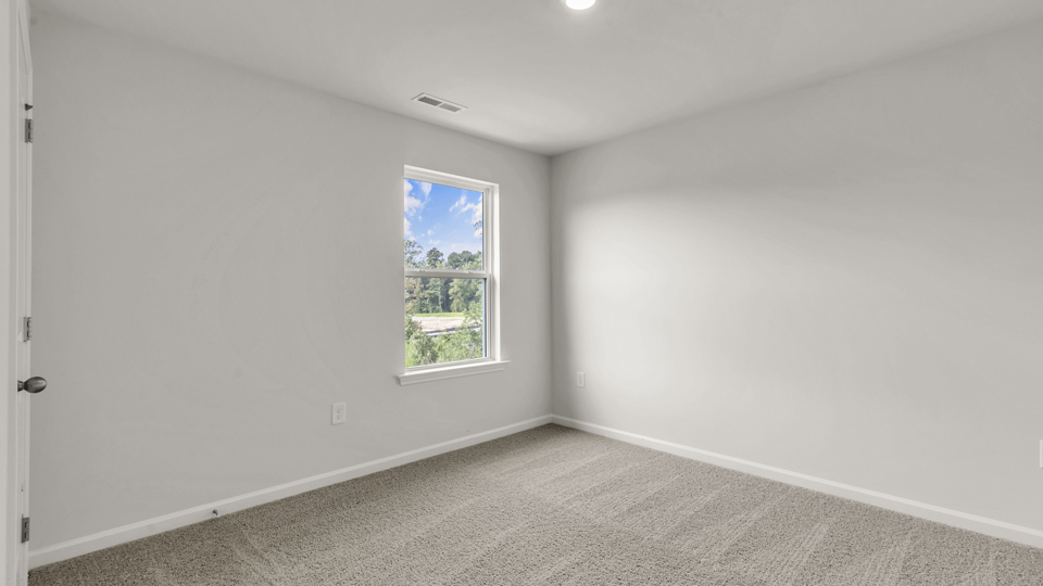 additional bedroom with window, carpeting, closet