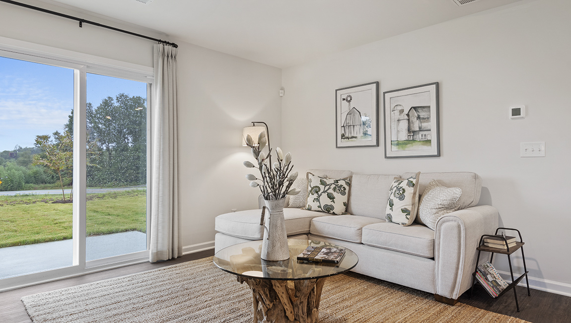 living area with ample lighting and vinyl flooring