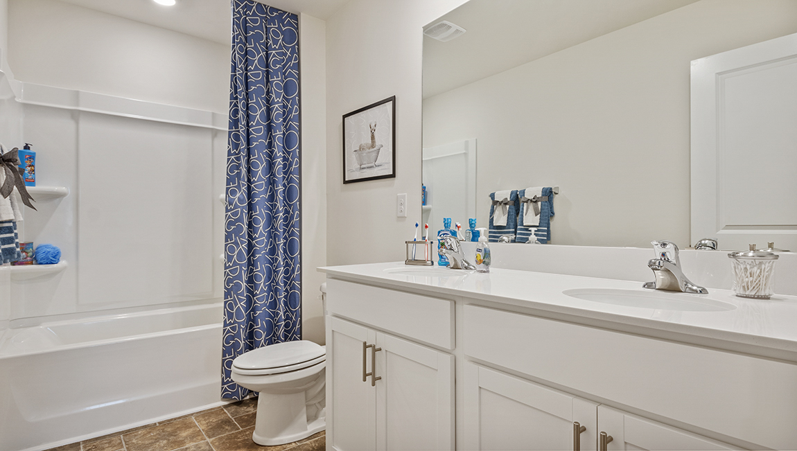 bathroom with quartz countertops and tub shower combo