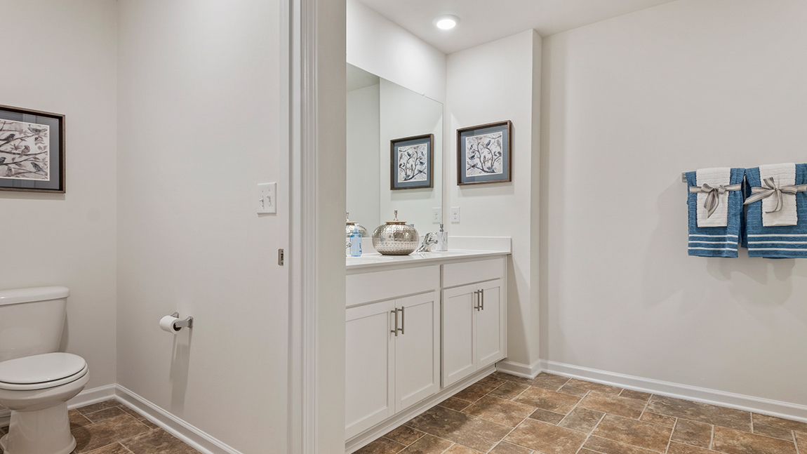 bathroom with quartz countertops and walk in shower