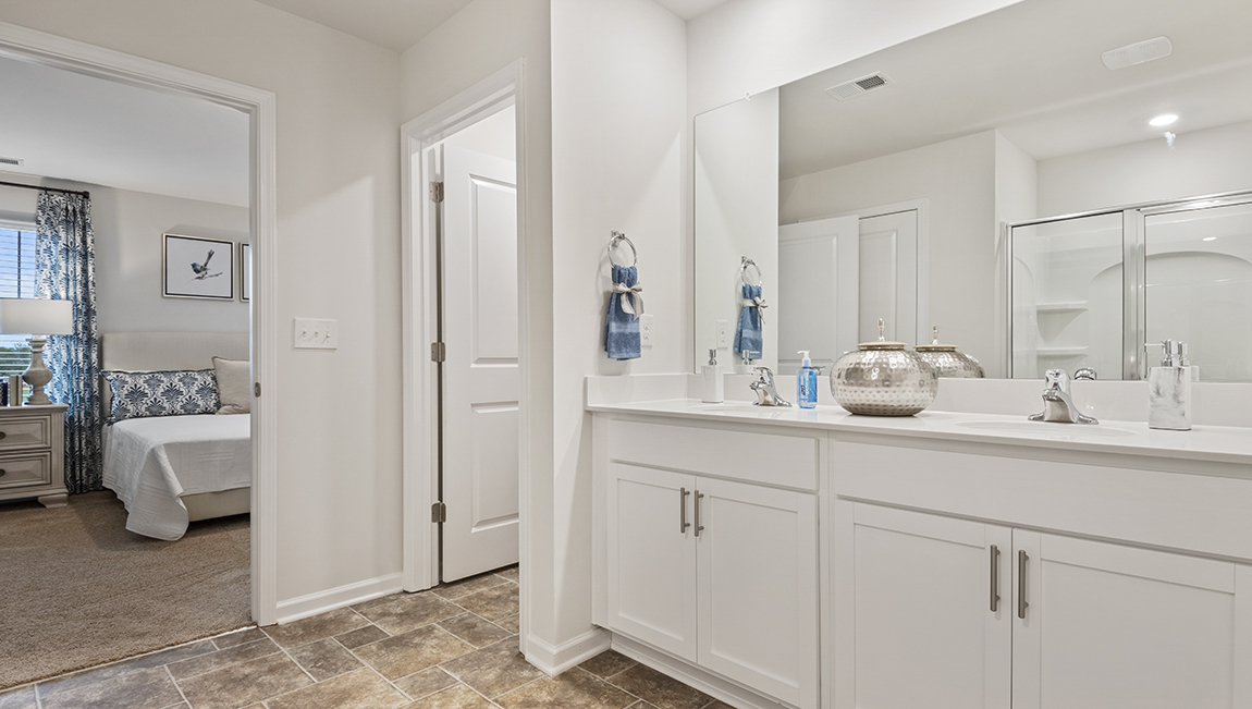 bathroom with quartz countertops and walk in shower