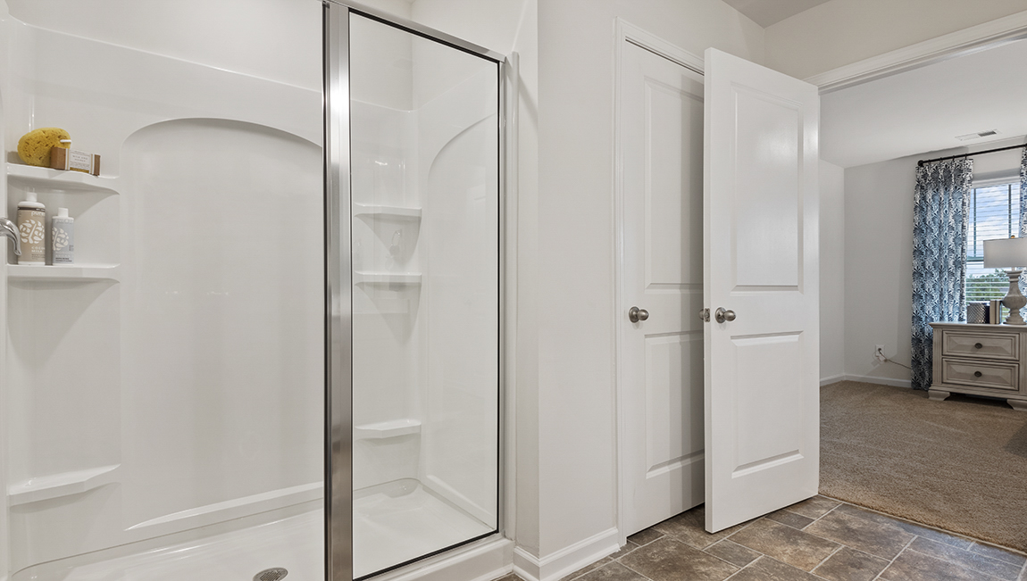 bathroom with quartz countertops and walk in shower