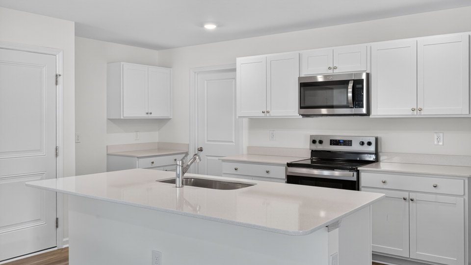 Kitchen with white cabinets and stainless steel appliances.