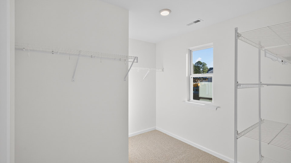 Primary bedroom walk-in closet