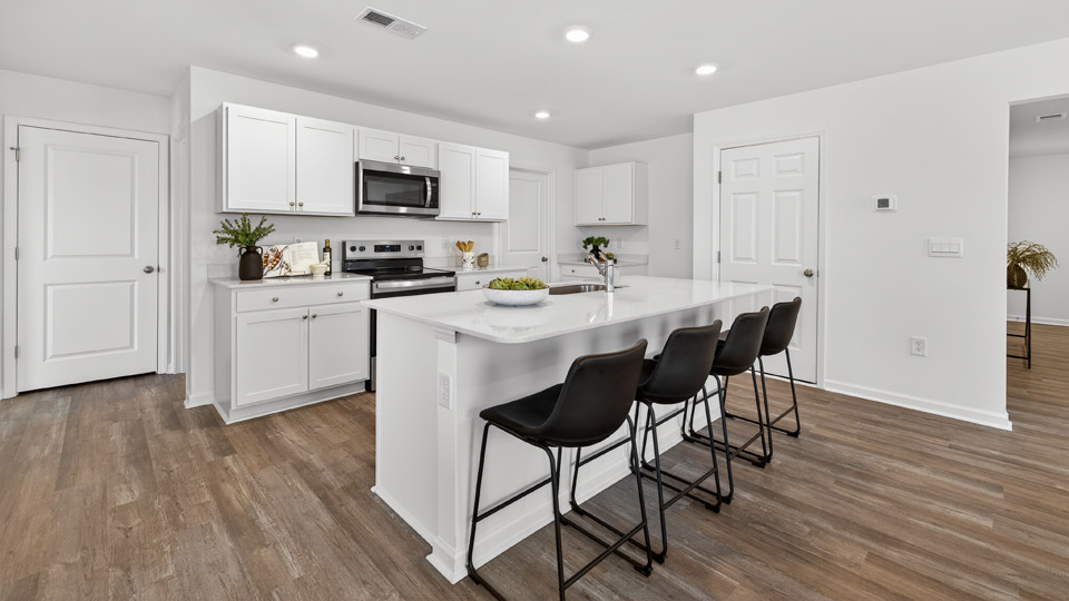 Kitchen with white cabinets and stainless steel appliances.