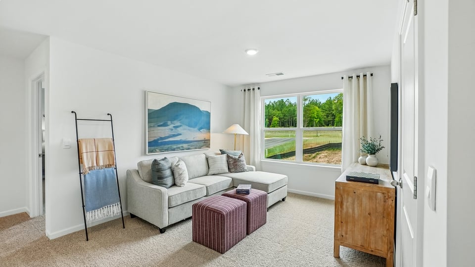 upstairs loft area with large windows and carpeting
