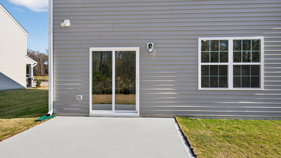 exterior patio with concrete slab and open yard