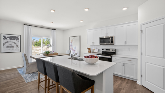 kitchen with island white cabinets and quartz countertops