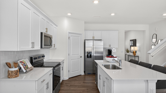 kitchen with island white cabinets and quartz countertops