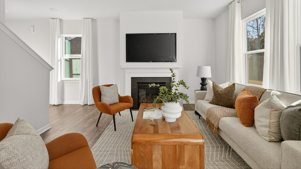 living room with revwood flooring and fireplace