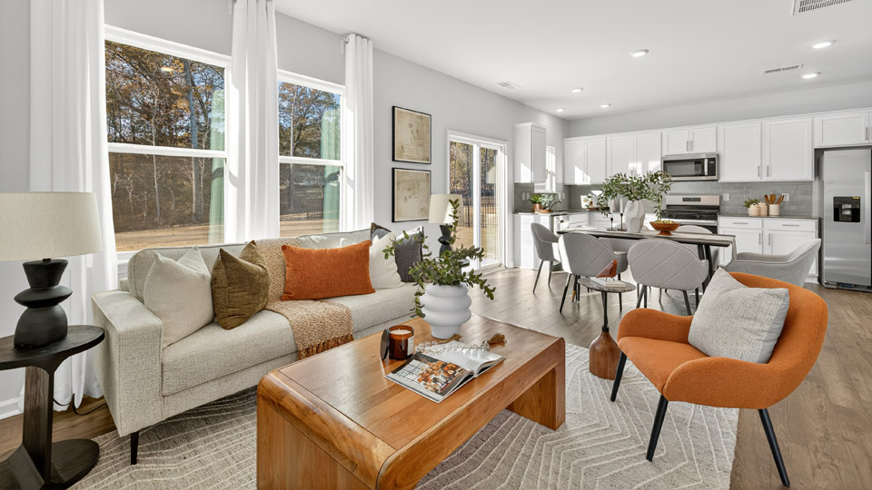 living room with revwood flooring overlooked by kitchen