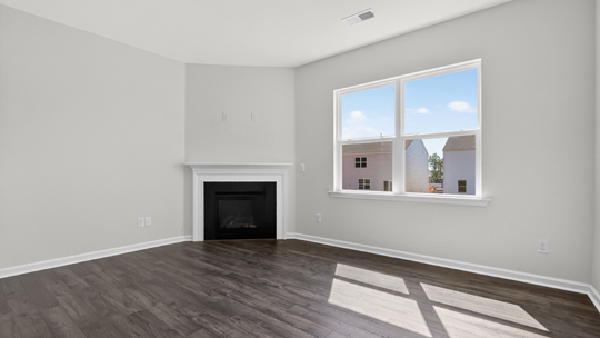 living room with revwood flooring and fireplace