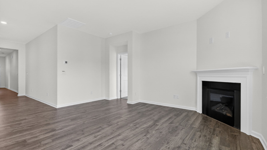 living room with revwood flooring and fireplace
