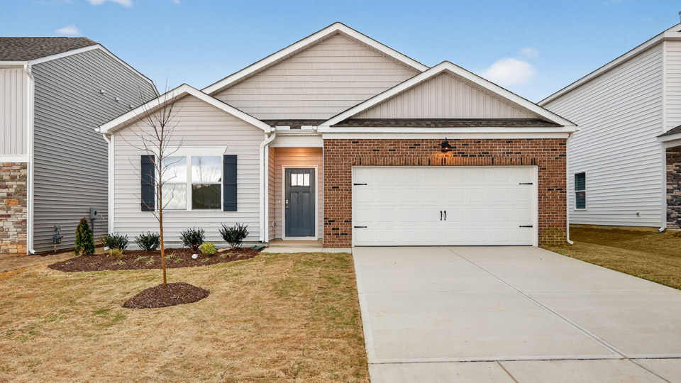 Single story home with white siding and a two-car garage.
