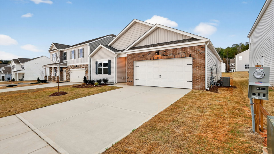 Single story home with white siding and a two-car garage.