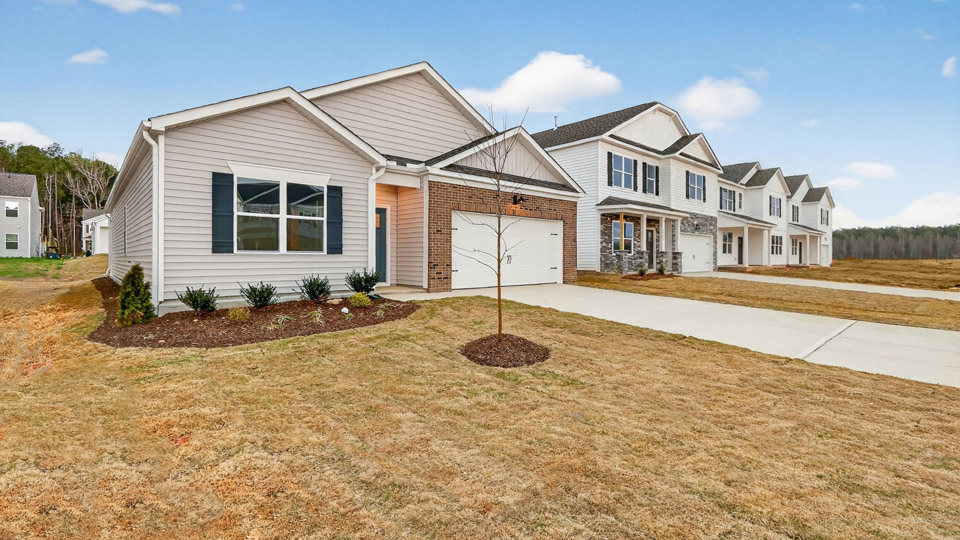 Single story home with white siding and a two-car garage.